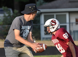 Coach Chris Brooks running handoff drill